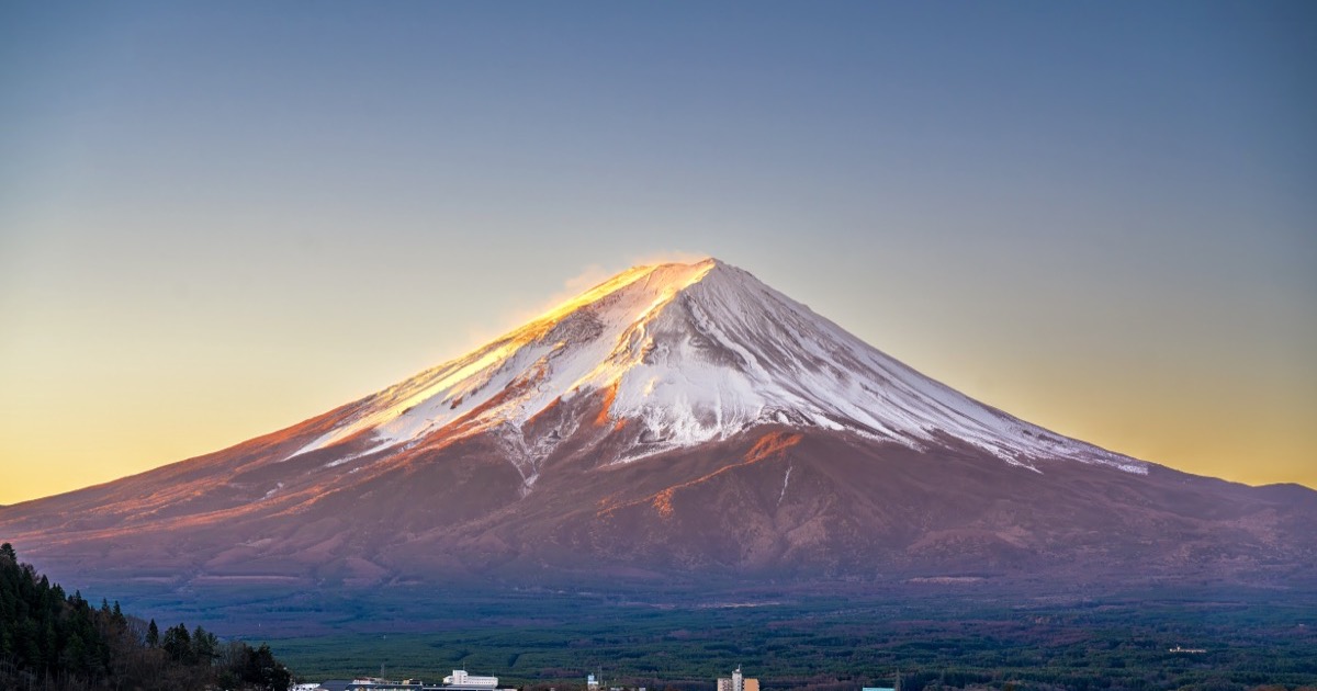 Mt. Fuji catching first light above the valley towns