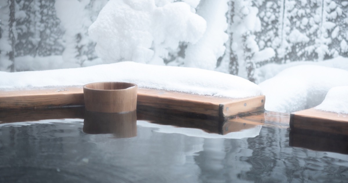 A snow-covered private open-air onsen bath
