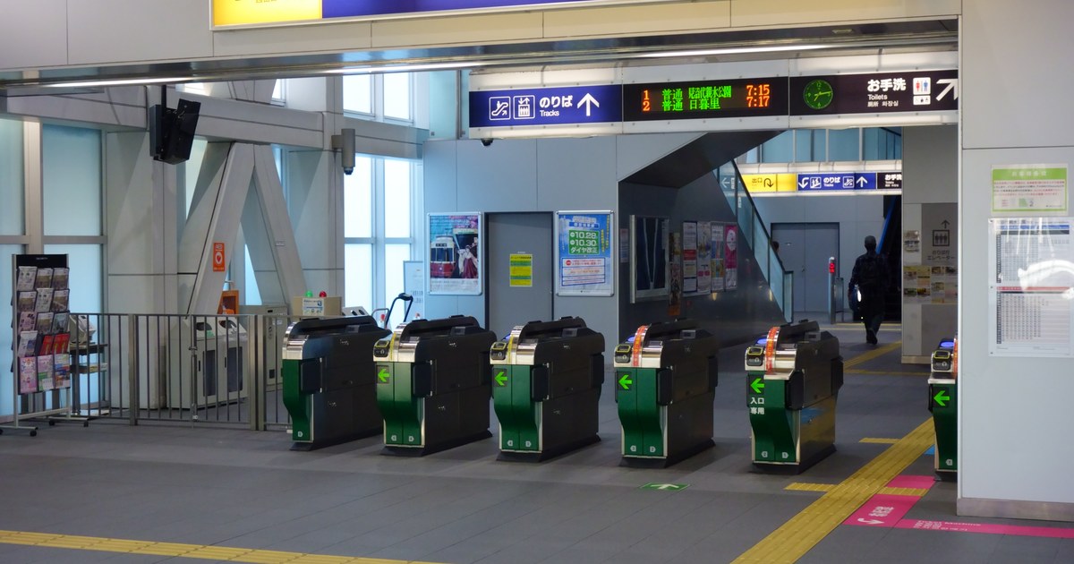 Ticket gates and departure boards at a Japanese station