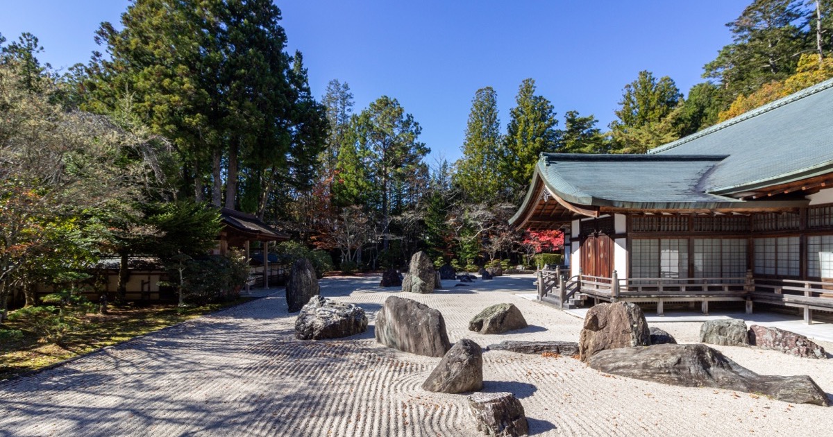 A raked rock garden at a Koyasan temple under a clear sky