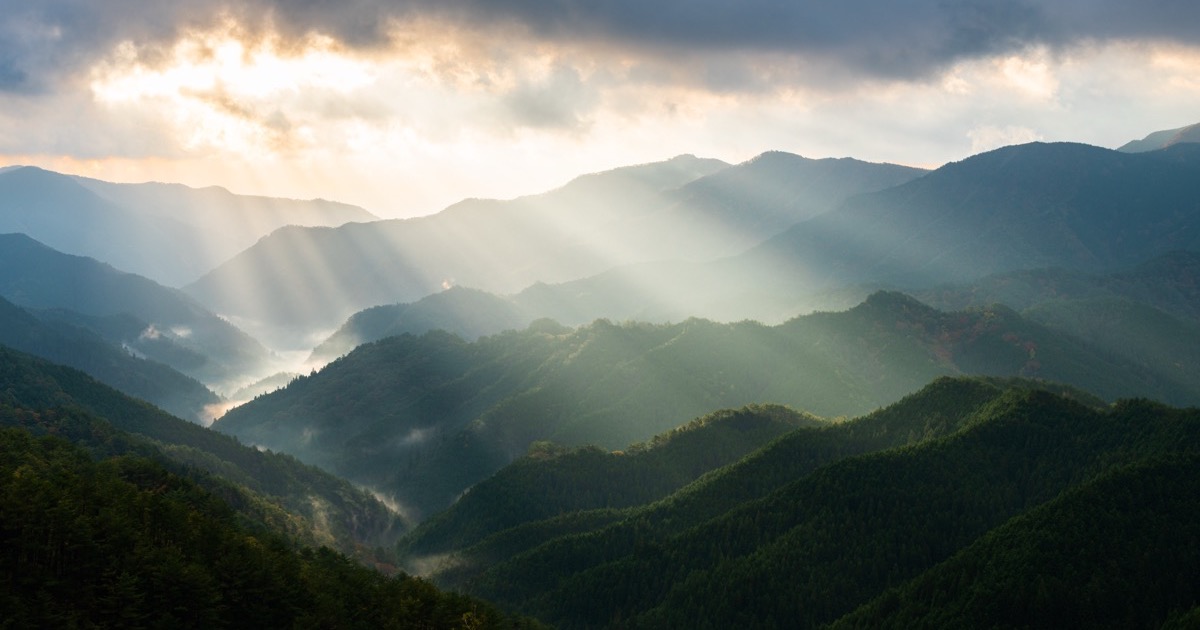 Morning light breaking over the Kumano mountains