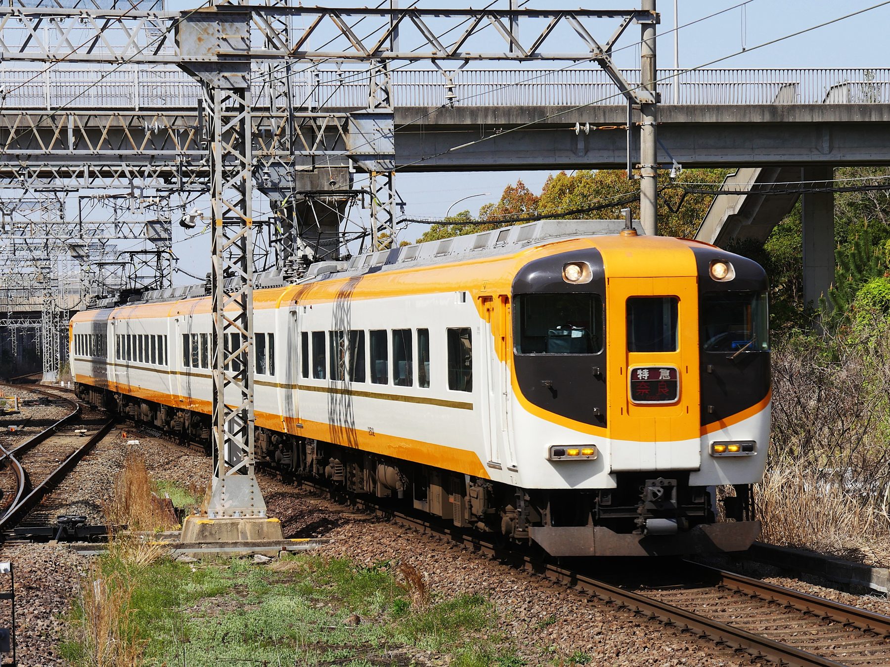 A Kintetsu limited express train in orange and white