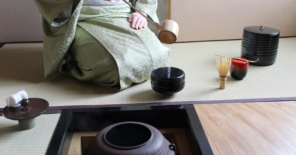 A tea ceremony host preparing matcha in a tatami room