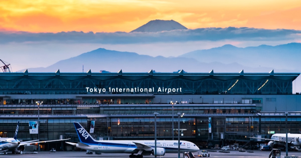 Haneda Airport at dusk with Mt. Fuji on the horizon