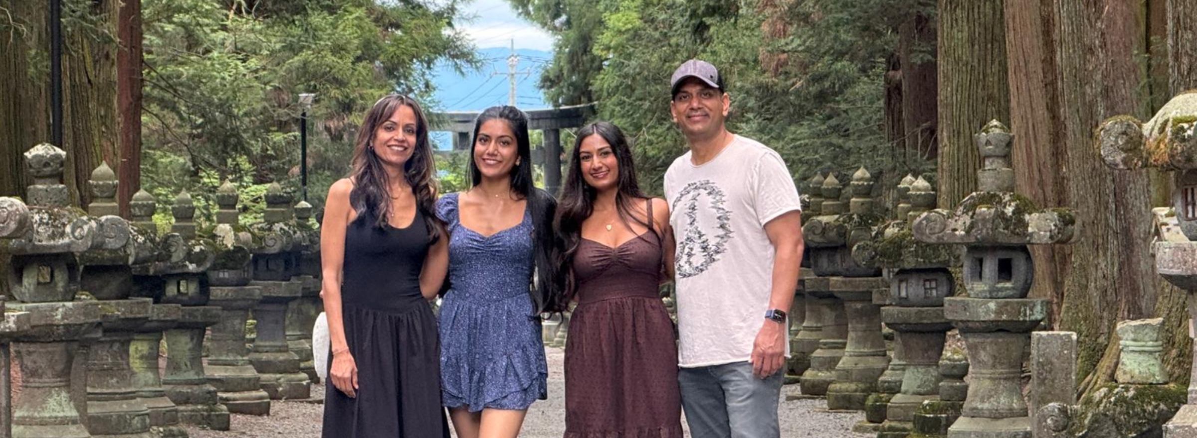 The family at a cedar-lined shrine approach