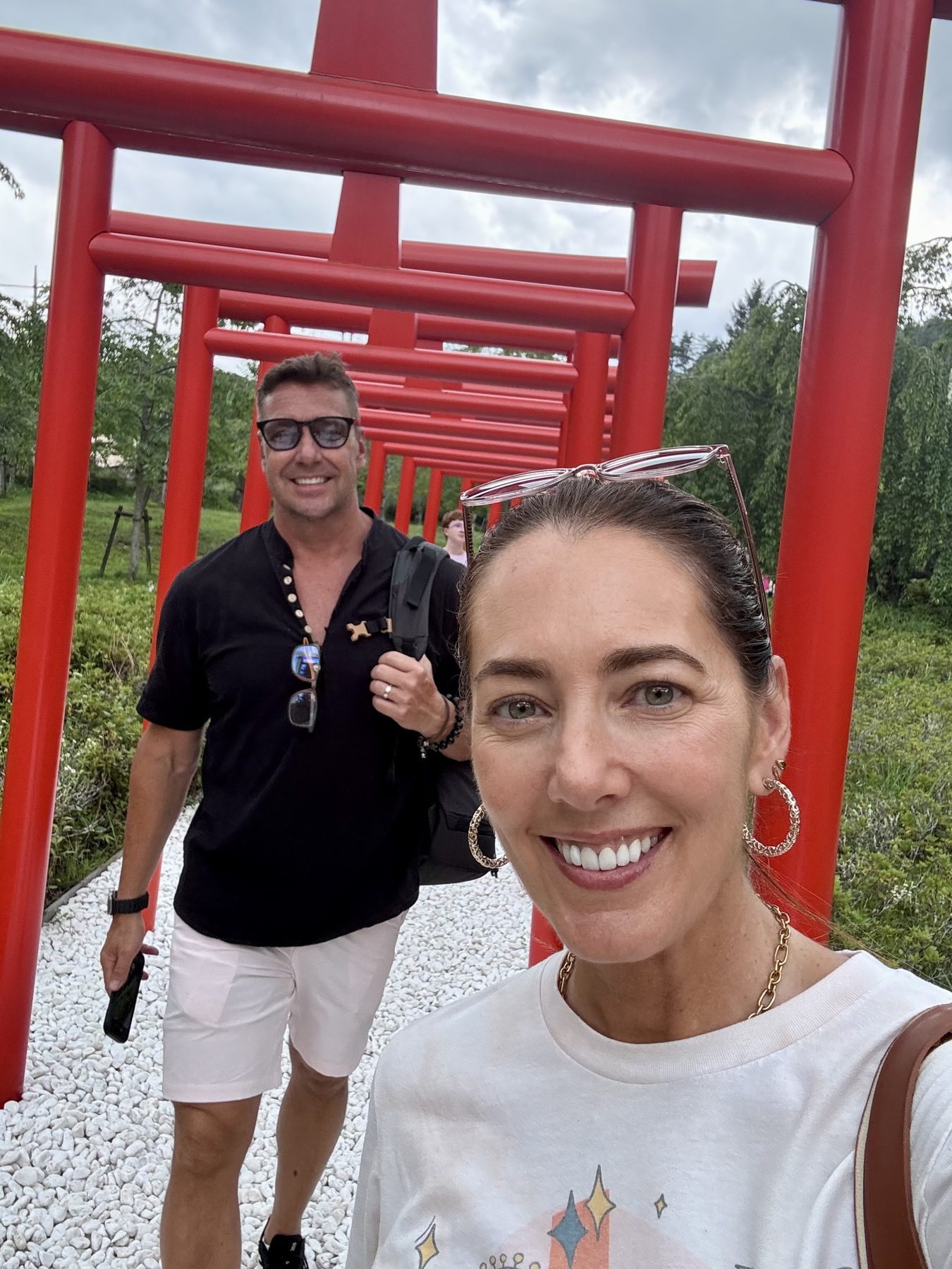 The parents beneath a row of red torii gates on the day trip to Mt. Fuji