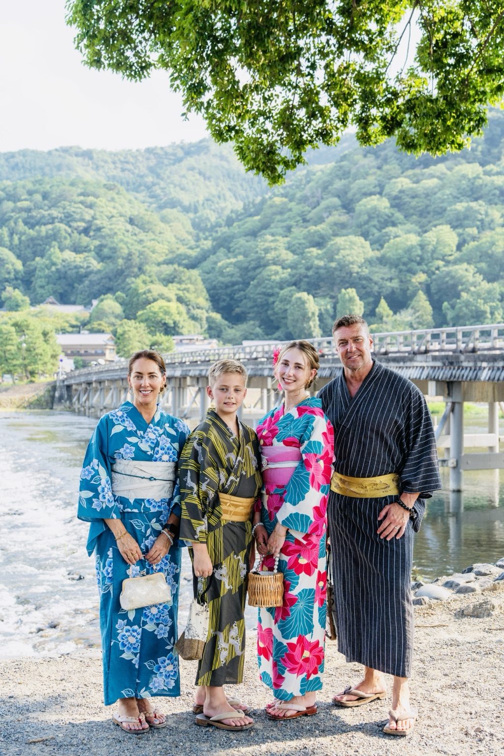 The family in kimono by the river in Arashiyama