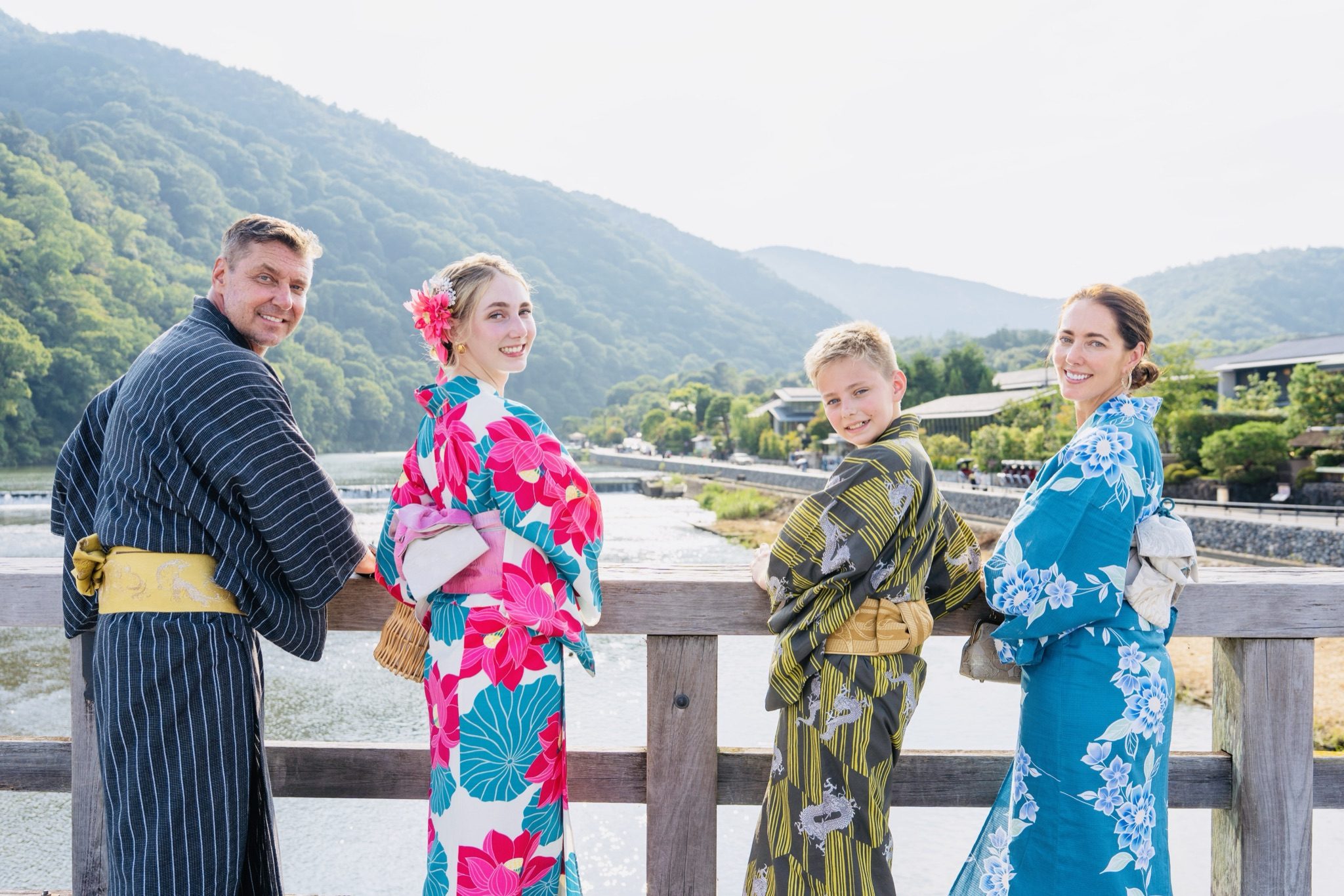 The family in kimono by the river in Arashiyama