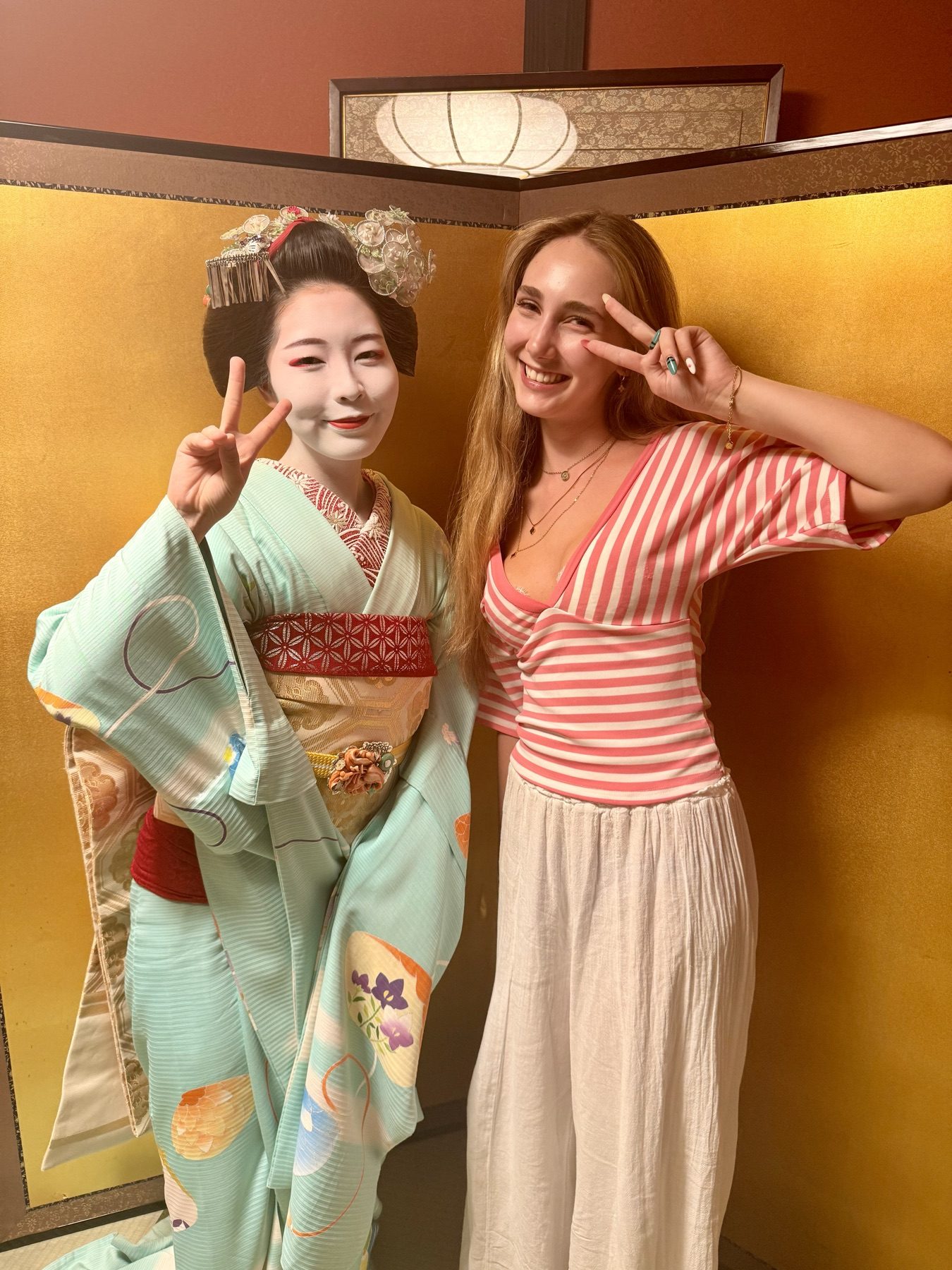 The family's daughter with a maiko in a private room in Gion
