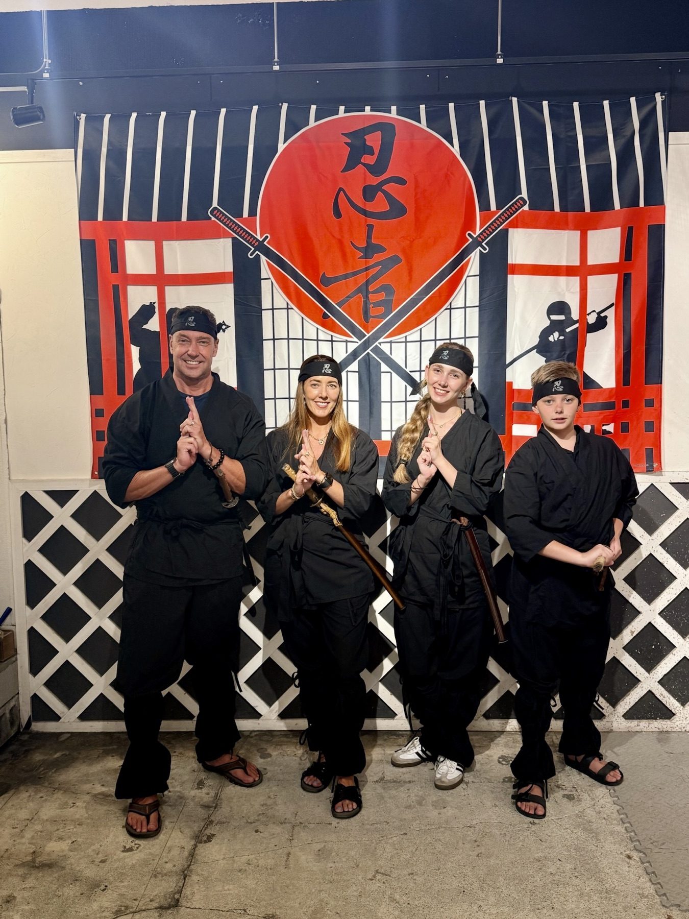 The family dressed as ninja at a ninja experience in Harajuku