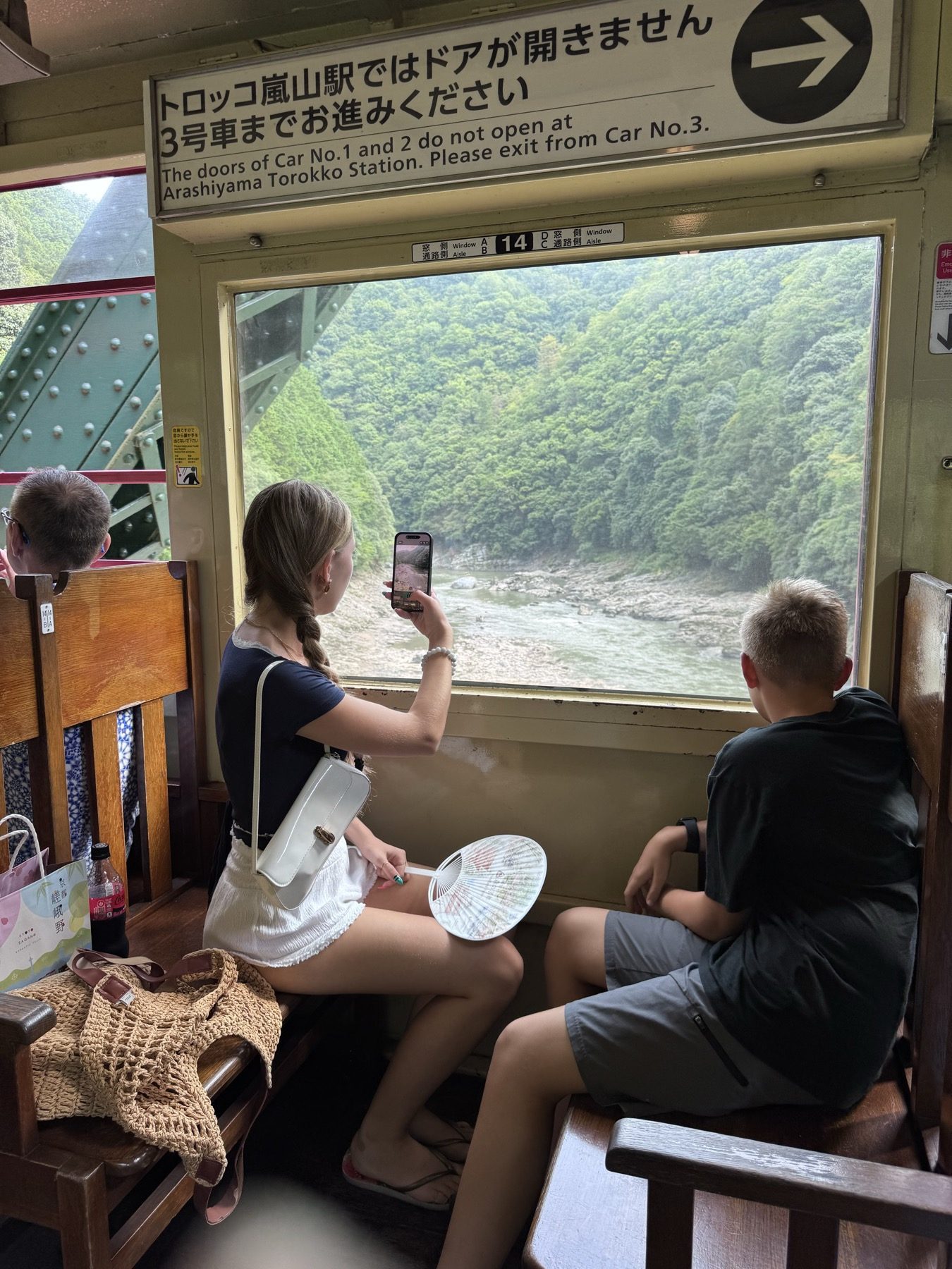 The kids looking out over the river gorge from the Sagano Scenic Railway